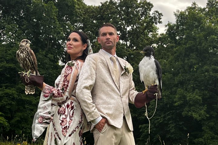 a group of baseball players standing on a grass field posing for the camera