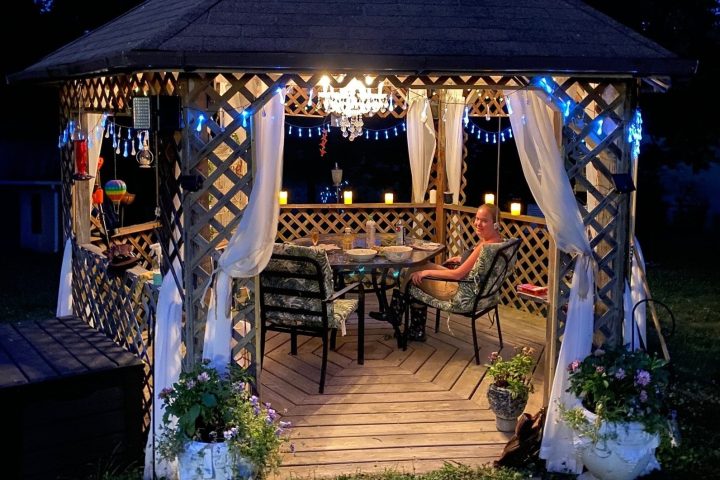 a gazebo with a dinner setup