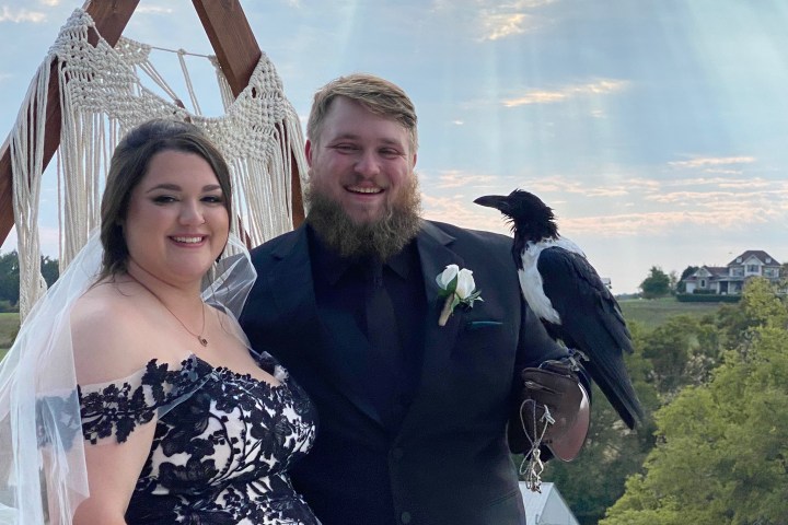 a man and a woman standing in front of a statue